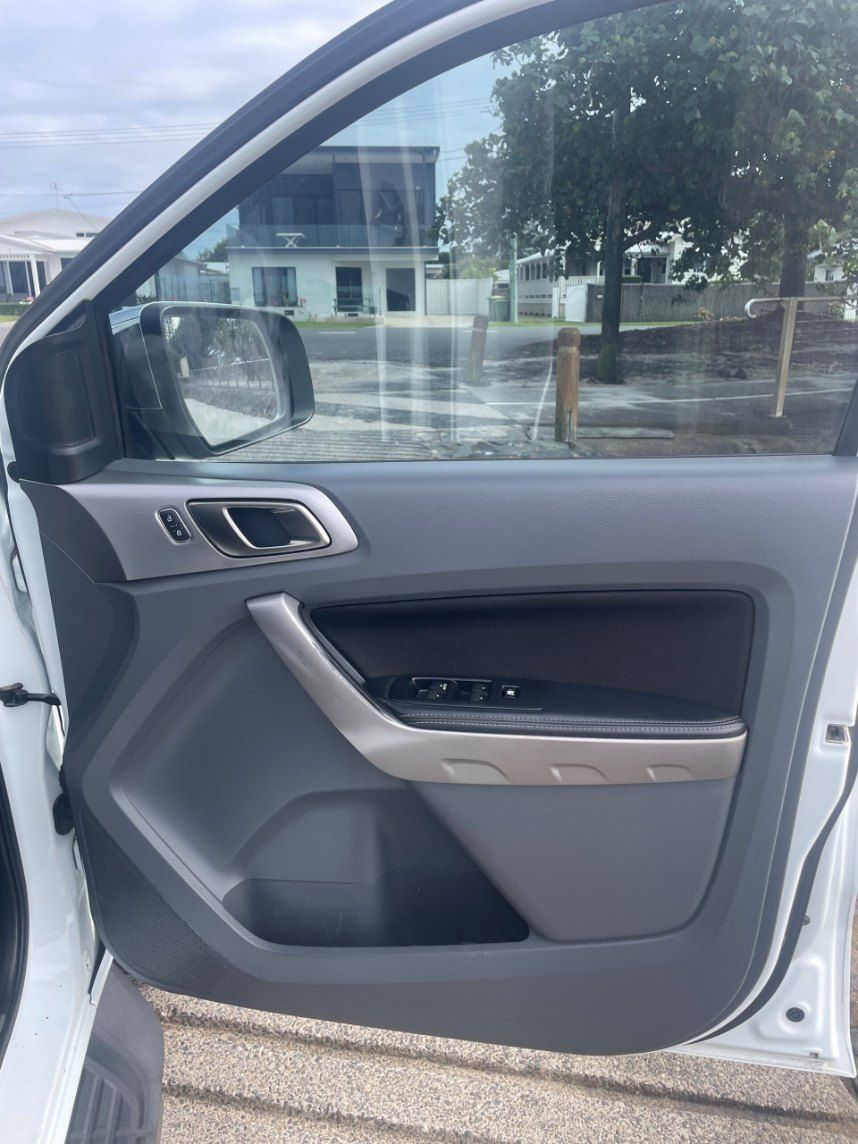 A White Car With the Door Open is Parked on the Side of the Road — Pelican Motors Service Centre In Caloundra West, QLD 