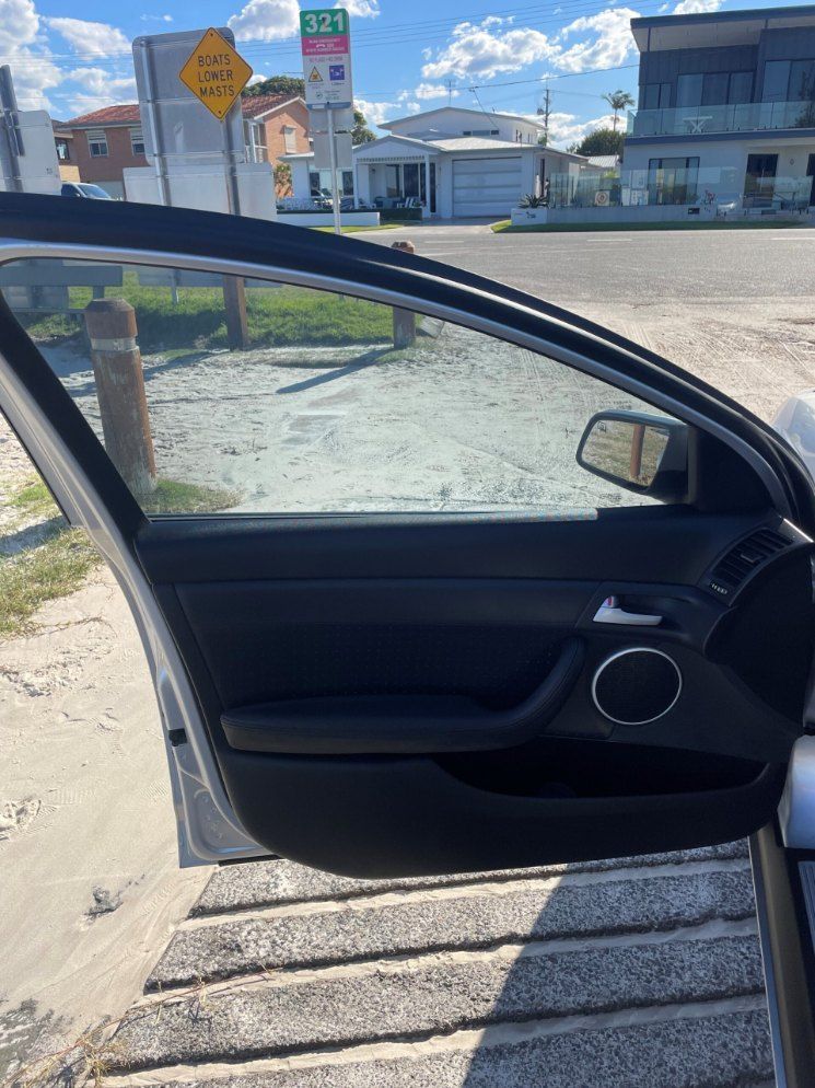 A Car is Parked on the Side of the Road With the Door Open — Pelican Motors Service Centre In Caloundra West, QLD 