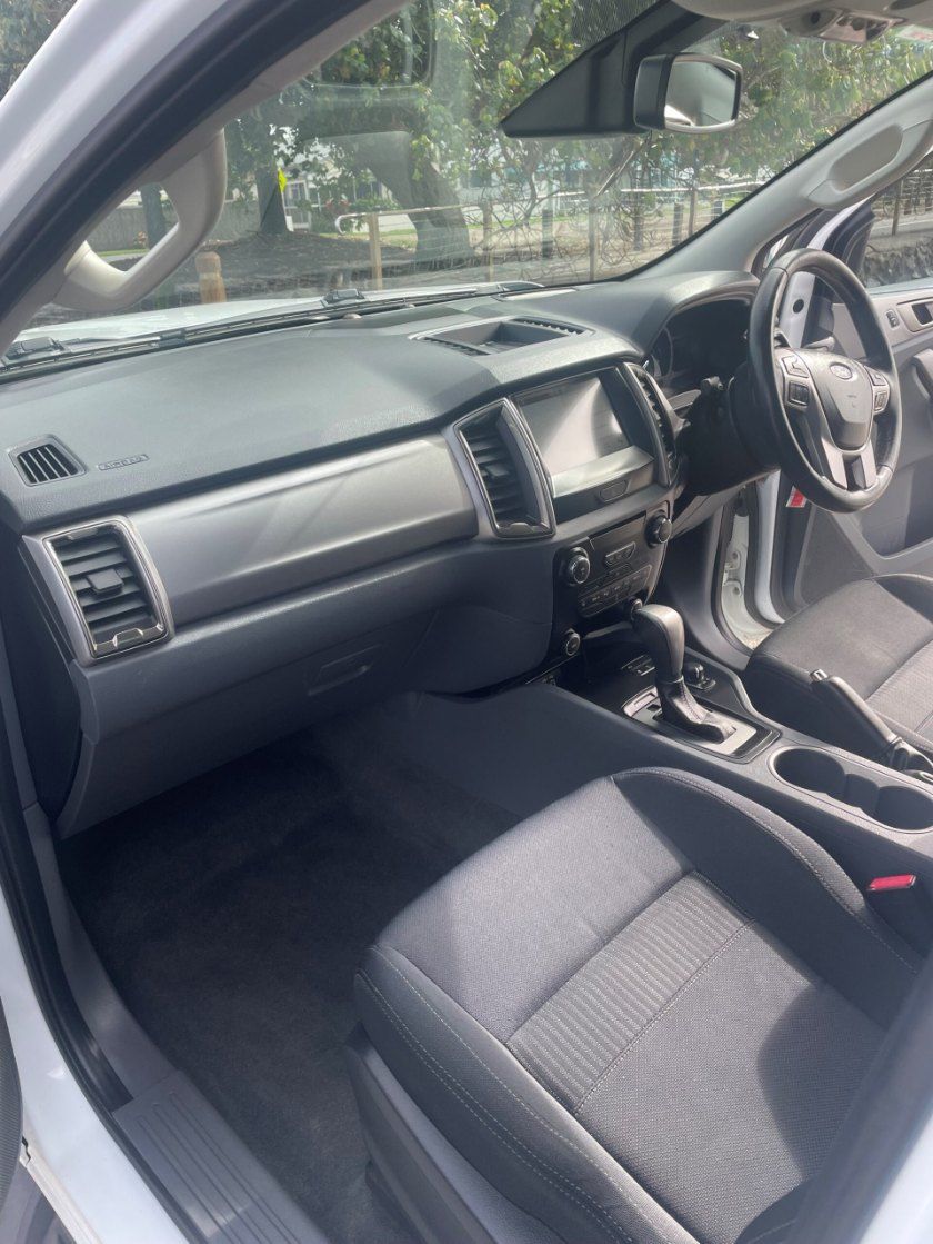 The Interior of a White Car With Black Seats and a Steering Wheel — Pelican Motors Service Centre In Caloundra West, QLD 