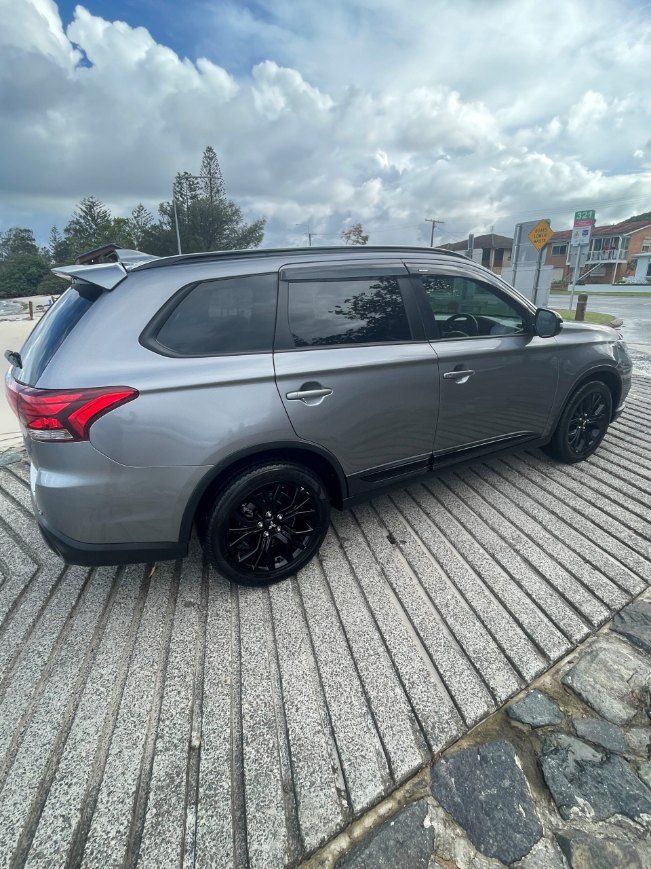 A Gray Suv is Parked on a Sidewalk Next to a Road — Pelican Motors Service Centre In Caloundra West, QLD 