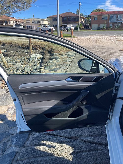 A White Car is Parked on the Side of the Road With the Door Open — Pelican Motors Service Centre In Caloundra West, QLD 