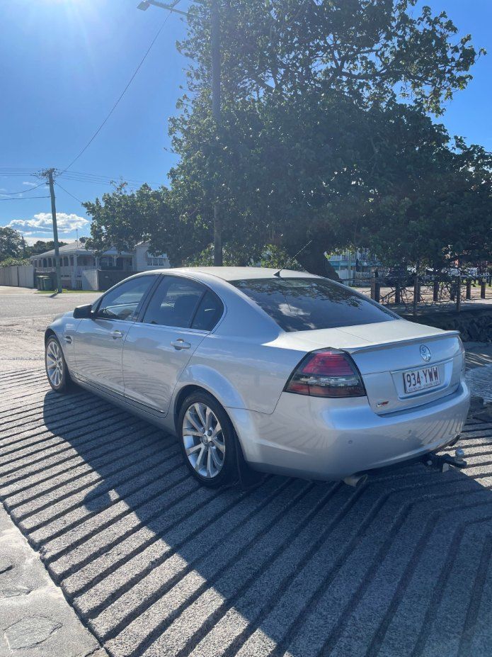 A Silver Car is Parked in a Parking Lot Next to a Tree — Pelican Motors Service Centre In Caloundra West, QLD 