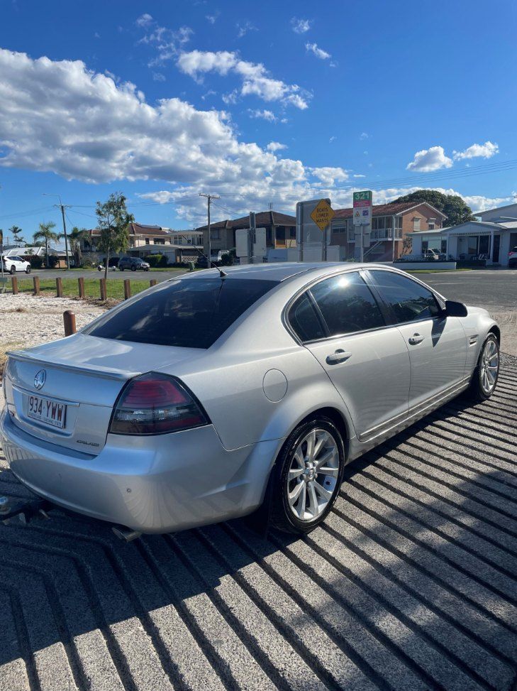 A White Car is Parked in a Parking Lot on a Sunny Day — Pelican Motors Service Centre In Caloundra West, QLD 