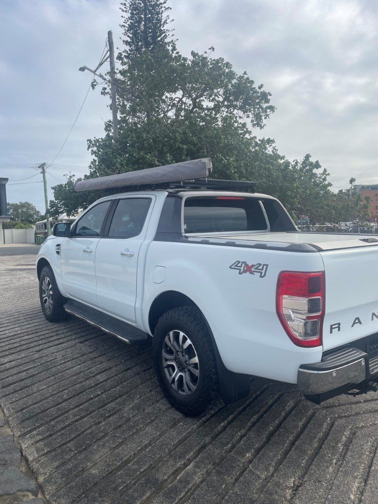 A White Truck With a Canopy on Top of It is Parked in a Parking Lot — Pelican Motors Service Centre In Caloundra West, QLD 