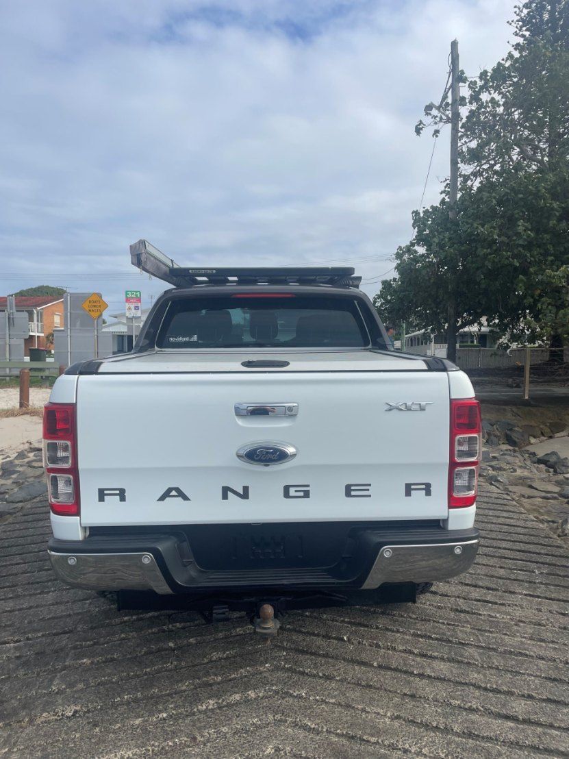 The Back of a White Ford Ranger Truck is Parked on a Brick Road — Pelican Motors Service Centre In Caloundra West, QLD 
