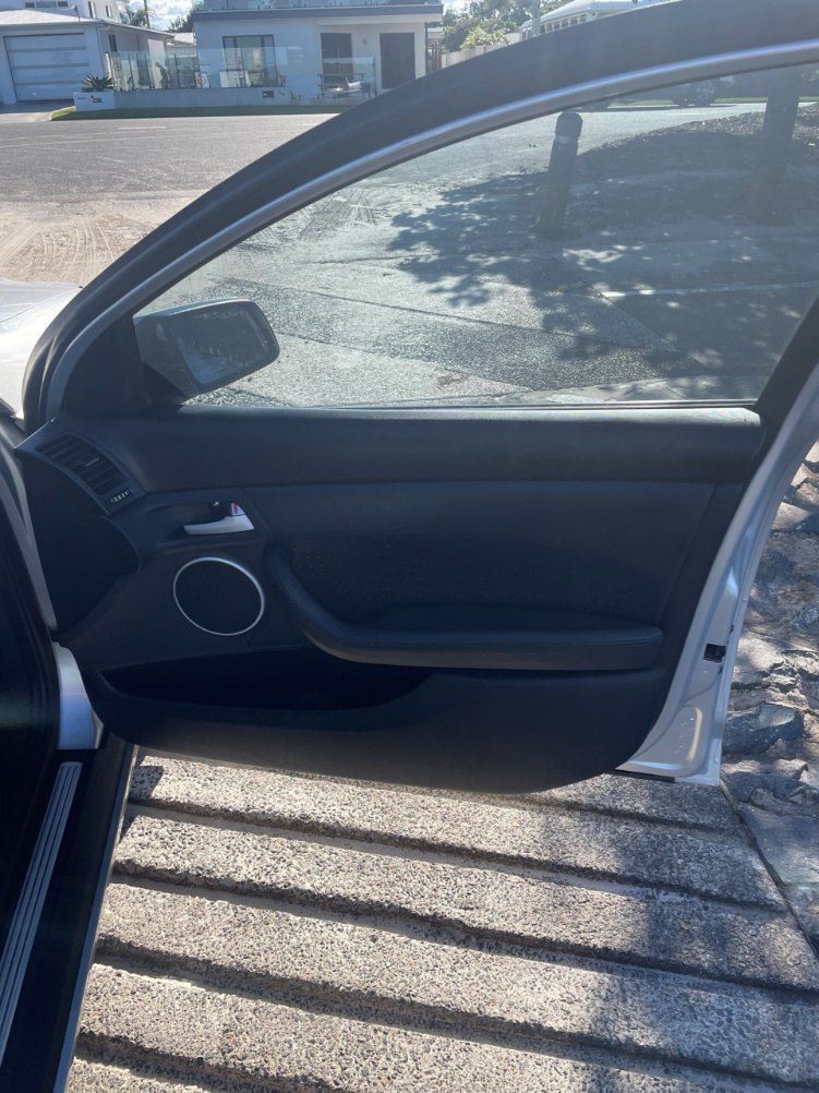 A Car With the Door Open is Parked on the Side of the Road — Pelican Motors Service Centre In Caloundra West, QLD 
