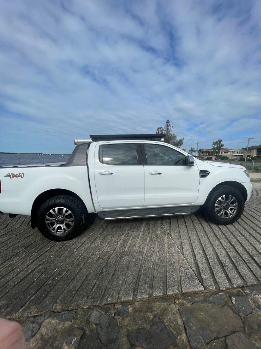 A White Ford Ranger Pickup Truck is Parked on the Side of the Road — Pelican Motors Service Centre In Caloundra West, QLD 