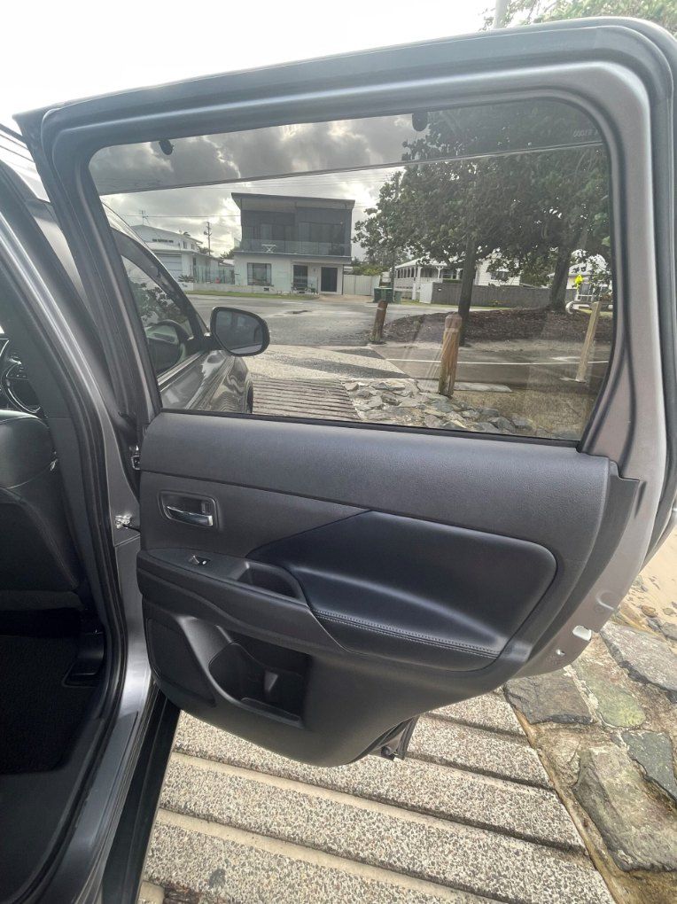 The Back Door of a Car is Open and There is a Tree in the Background — Pelican Motors Service Centre In Caloundra West, QLD 
