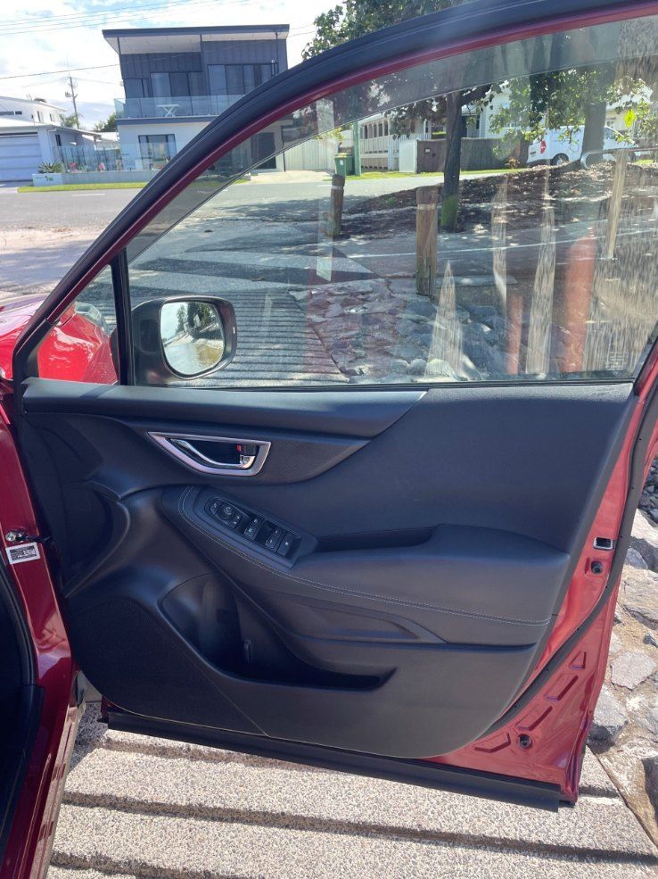 A Red Car With the Door Open is Parked on the Side of the Road — Pelican Motors Service Centre In Caloundra West, QLD 