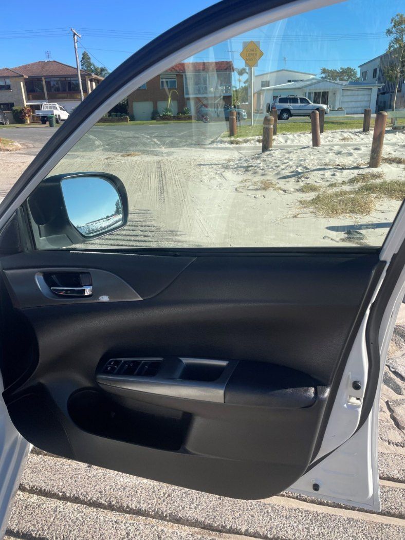 A White Car is Parked on the Side of the Road With the Door Open — Pelican Motors Service Centre In Caloundra West, QLD 