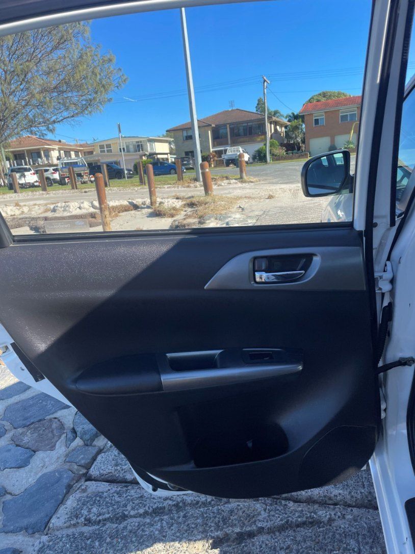 The Back Door of a White Car With the Door Open — Pelican Motors Service Centre In Caloundra West, QLD 