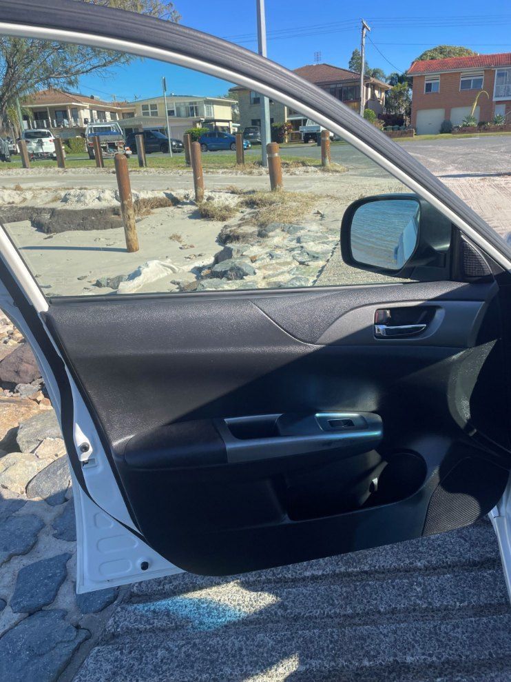 A Car is Parked on the Side of the Road With the Door Open — Pelican Motors Service Centre In Caloundra West, QLD 