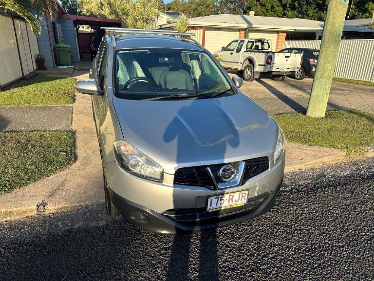 A Silver Nissan Car is Parked on the Side of the Road — Pelican Motors Service Centre In Caloundra West, QLD 