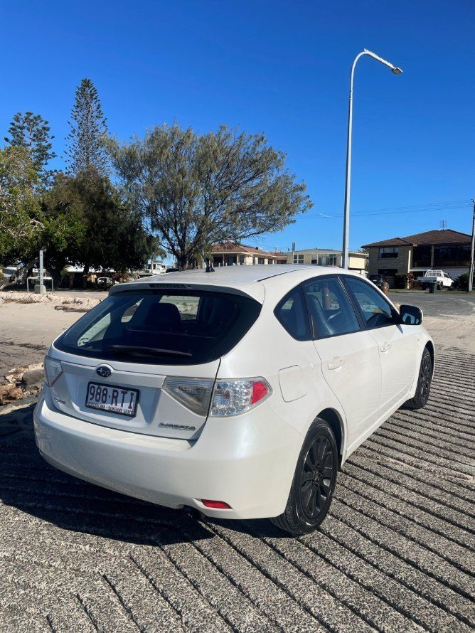 A White Subaru Impreza is Parked in a Parking Lot — Pelican Motors Service Centre In Caloundra West, QLD 