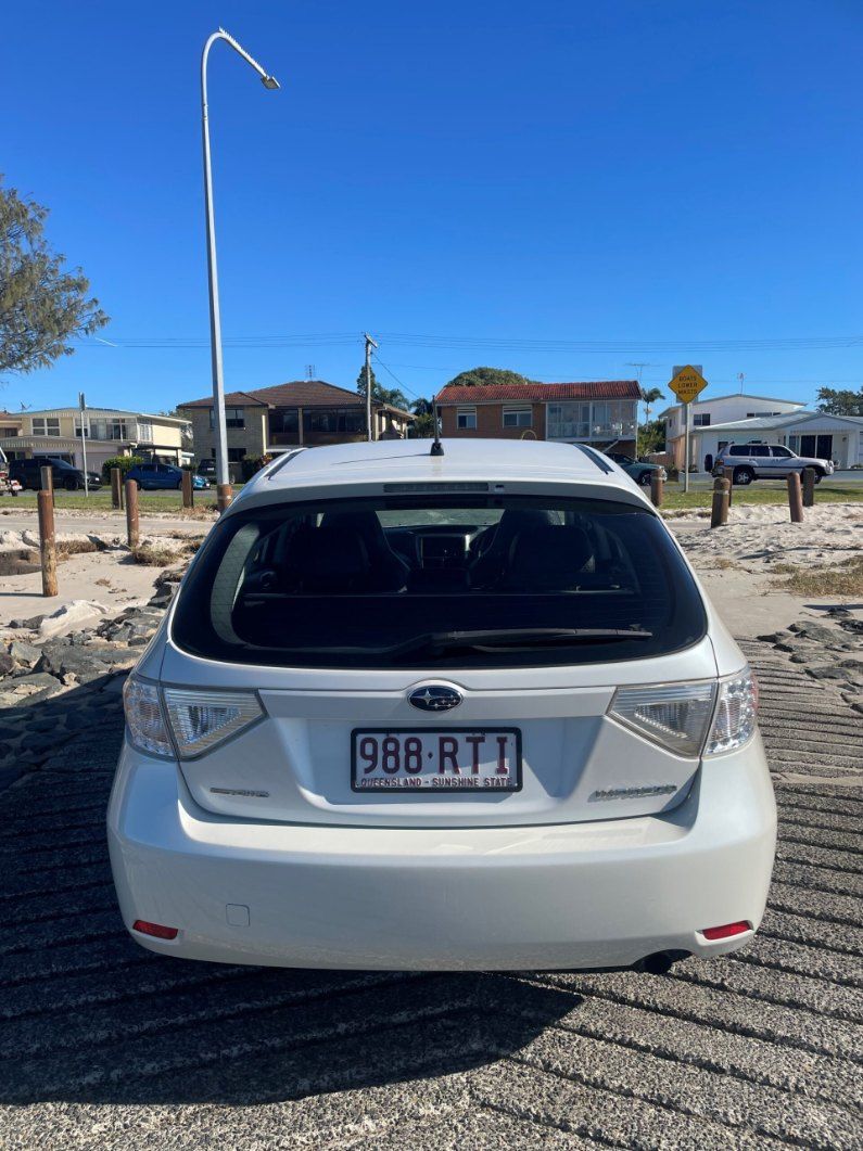 The Back of a White Car is Parked in a Parking Lot — Pelican Motors Service Centre In Caloundra West, QLD 
