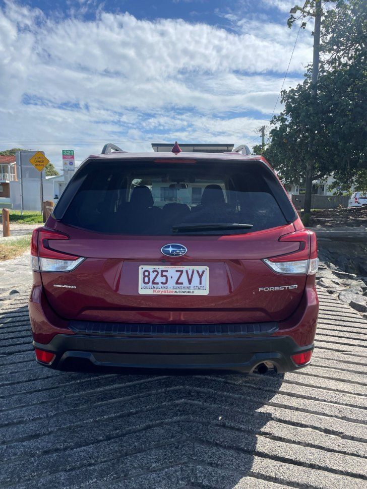 The Back of a Red Subaru Forester is Parked on the Side of the Road — Pelican Motors Service Centre In Caloundra West, QLD 