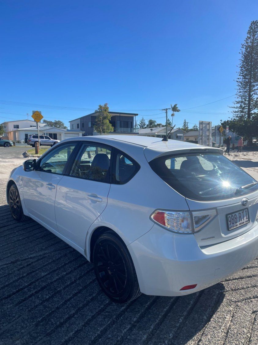A White Car is Parked in a Parking Lot on a Sunny Day — Pelican Motors Service Centre In Caloundra West, QLD 