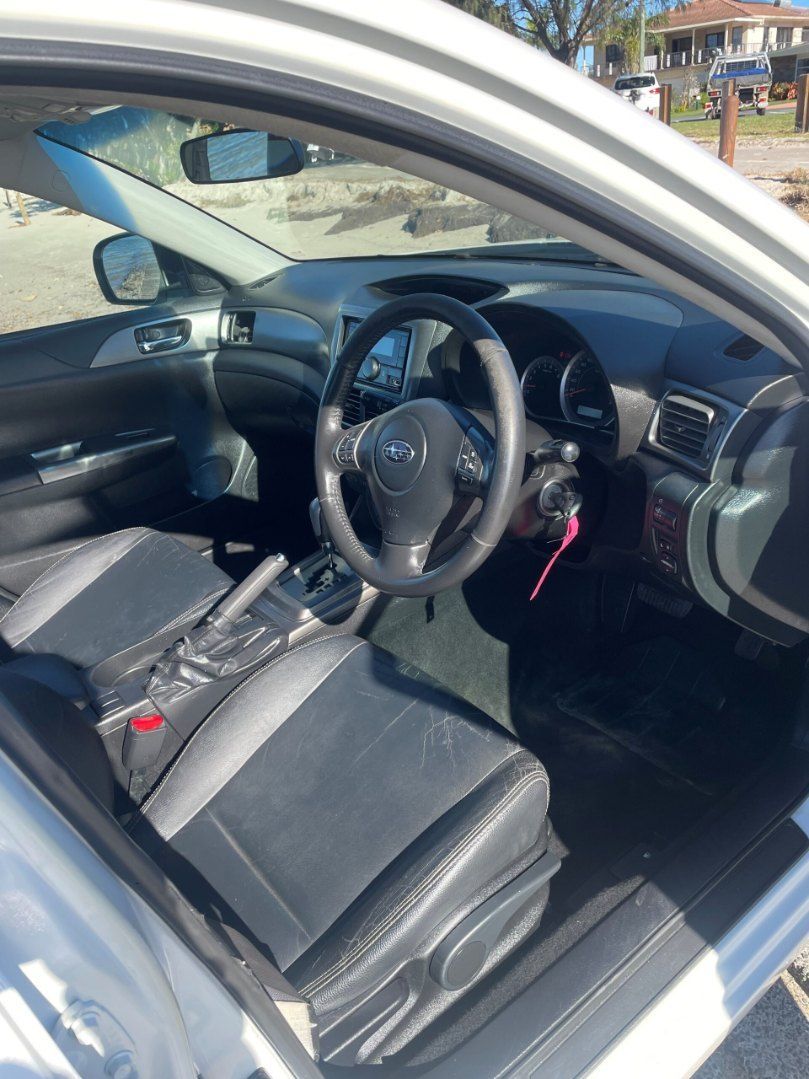 The Interior of a White Car With Black Seats and a Steering Wheel — Pelican Motors Service Centre In Caloundra West, QLD 