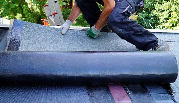 Man Working on Flat Roof Installation — Lakeport, CA — Lucerne Roofing & Supply Corp