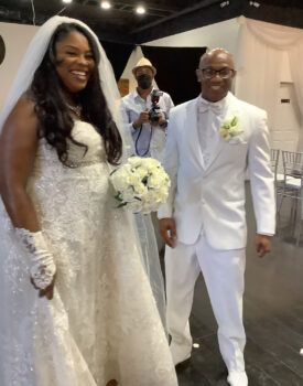 A bride and groom are posing for a picture together