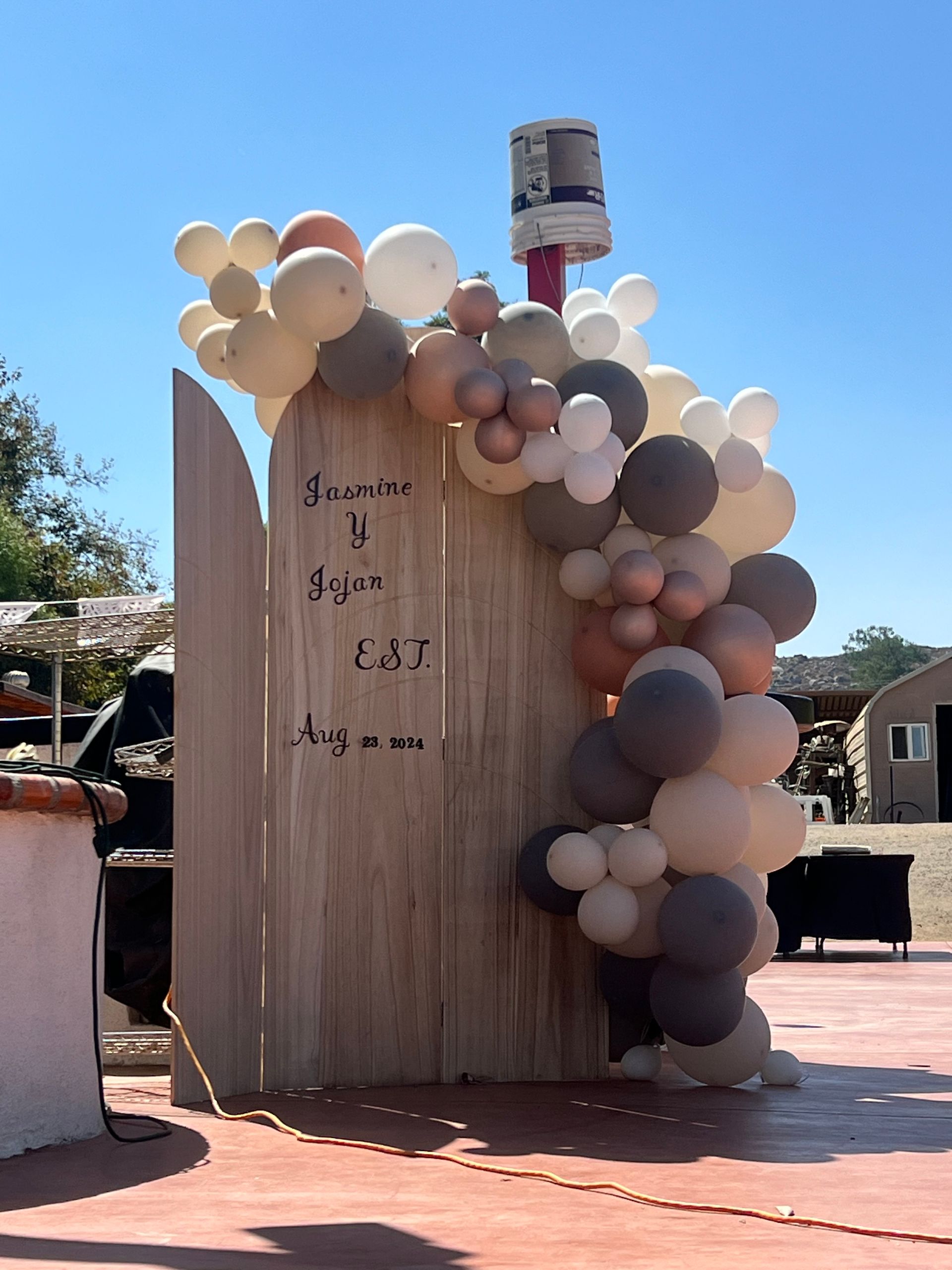 A wooden wall with balloons hanging from it