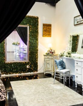 A room with a large mirror on the wall and a rug on the floor.