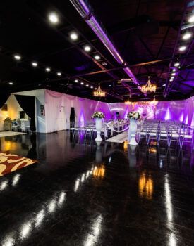 A large room with a lot of chairs and flowers in it