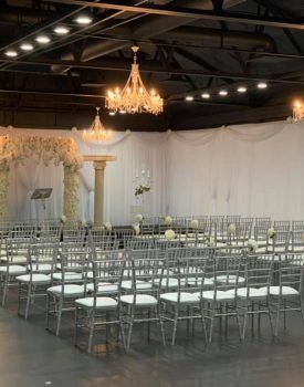 A large room filled with rows of chairs and a podium.