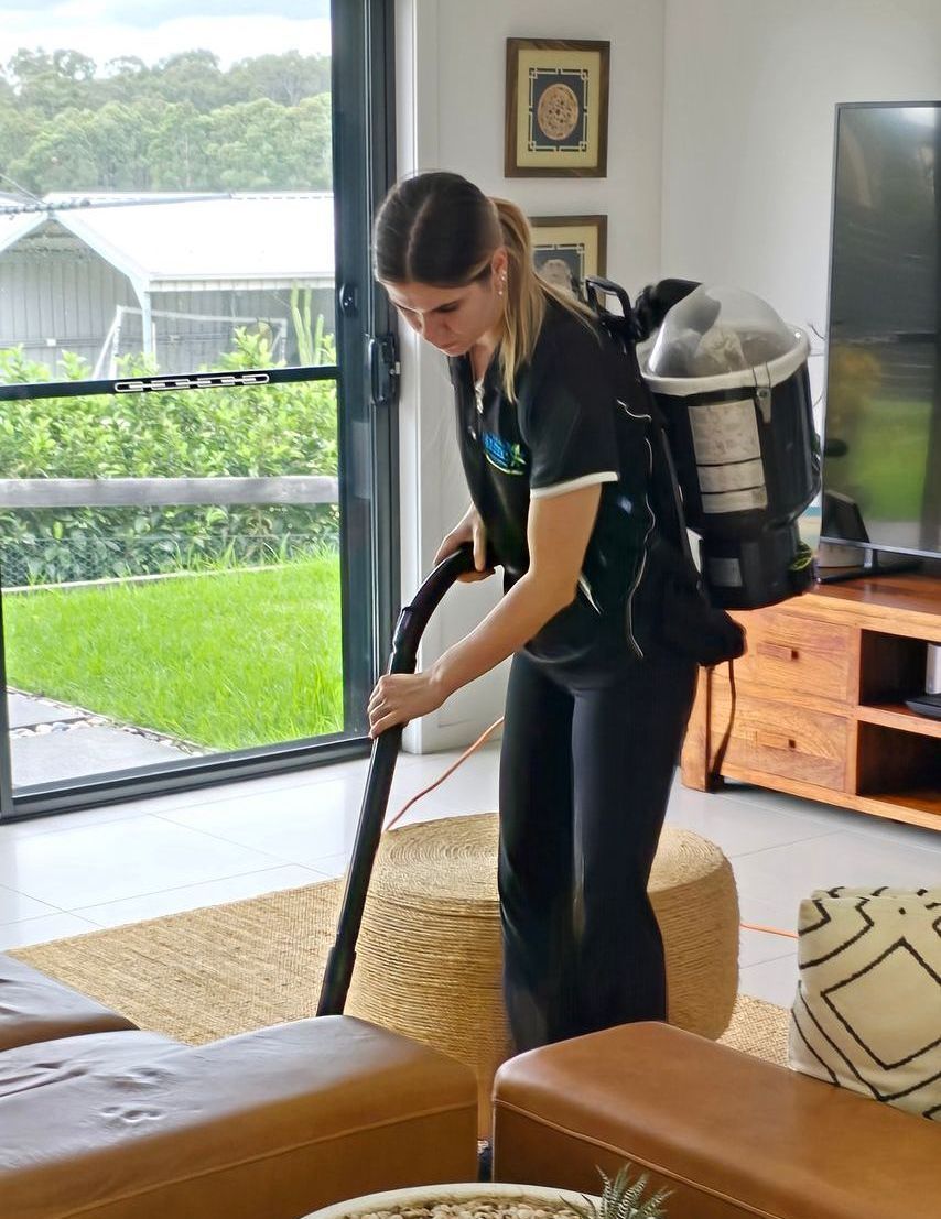 A lady is vacuuming living area — A Place 2 Shine In Maitland, NSW