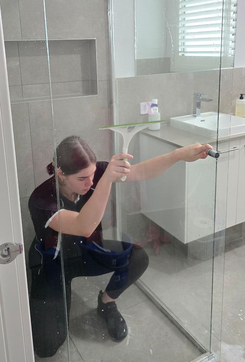 A girl is inside the shower while cleaning glass — A Place 2 Shine In Chisholm, NSW