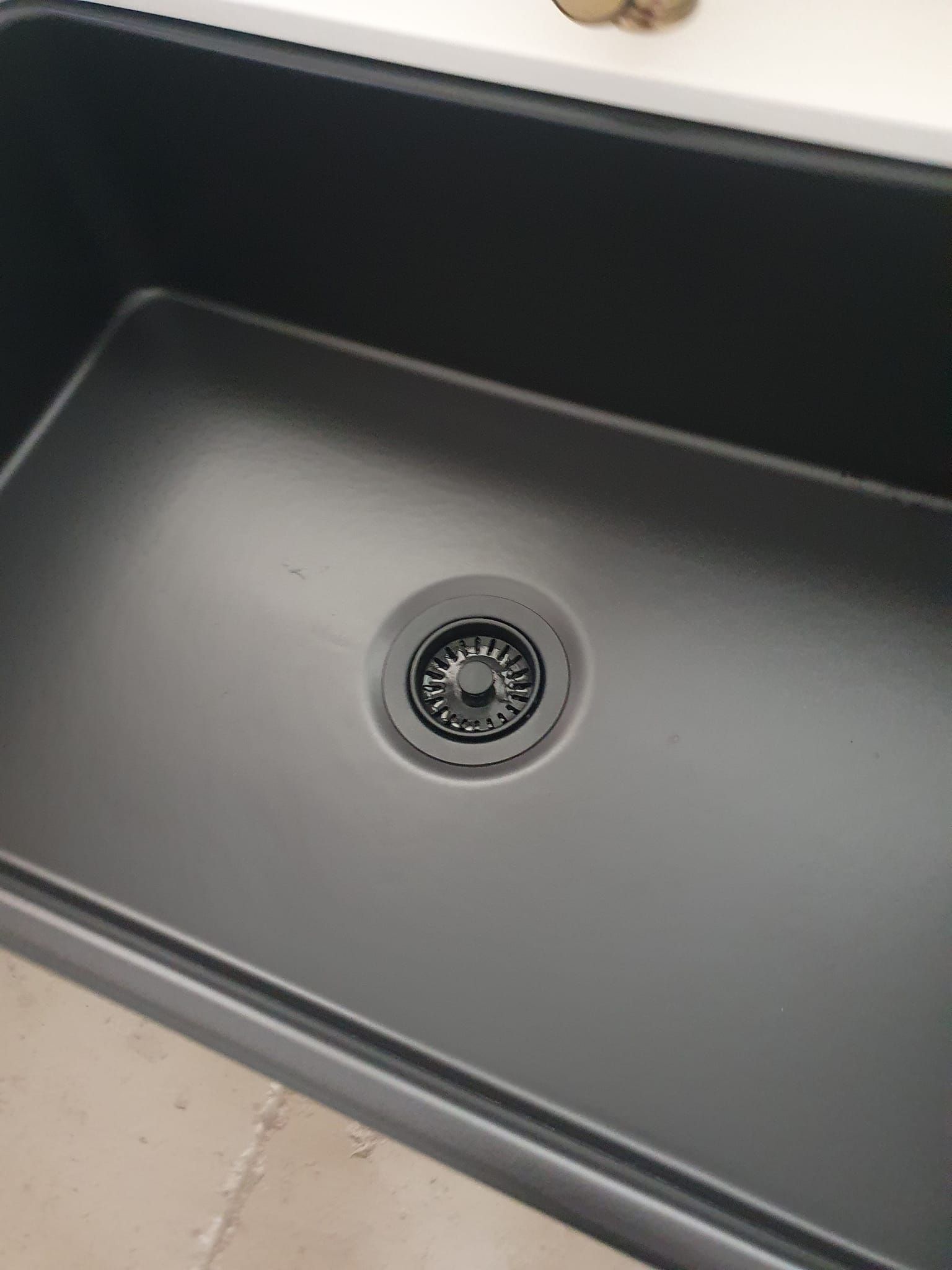 A Black Kitchen Sink With a Drain on the Bottom of It — A Place 2 Shine In Chisholm, NSW