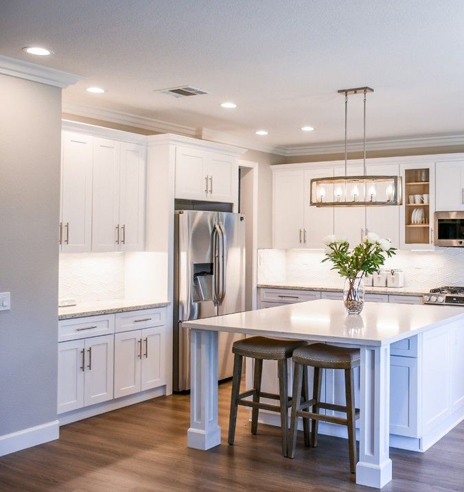 A Kitchen With White Cabinets and Stainless Steel Appliances — A Place 2 Shine In Chisholm, NSW