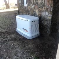 White Generator Sitting Next To A Stone Wall - Woodward, OK - Moyer Electric