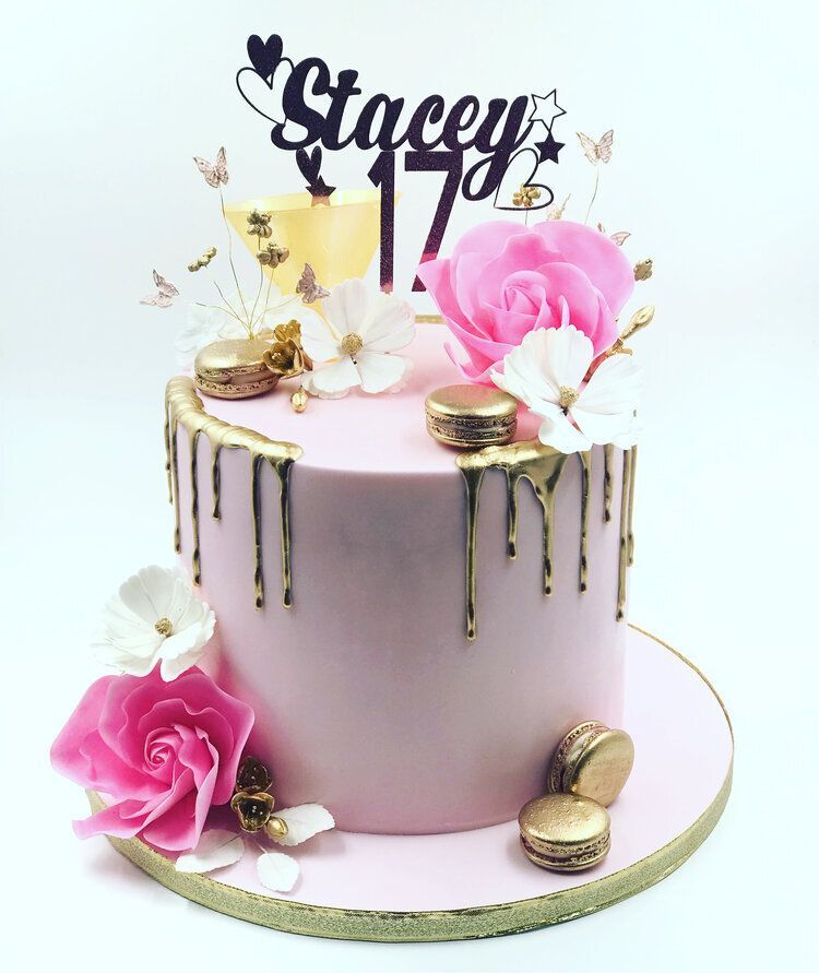 A pink cake with flowers and a topper for stacey 17