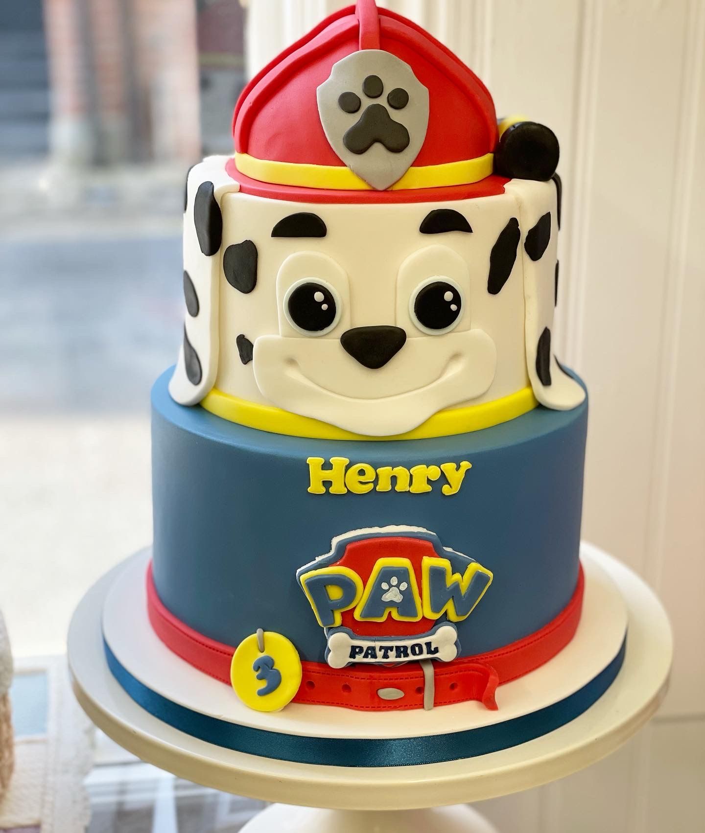 A paw patrol cake with the name henry on it