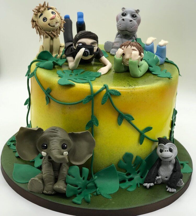 A yellow cake with animals on top of it
