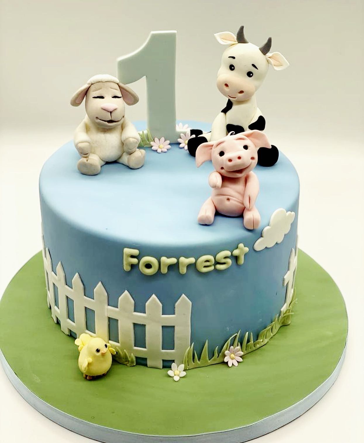 A blue cake with the name forrest on it