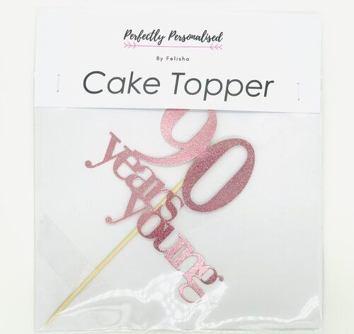 A cake topper for a 90th birthday is in a package.