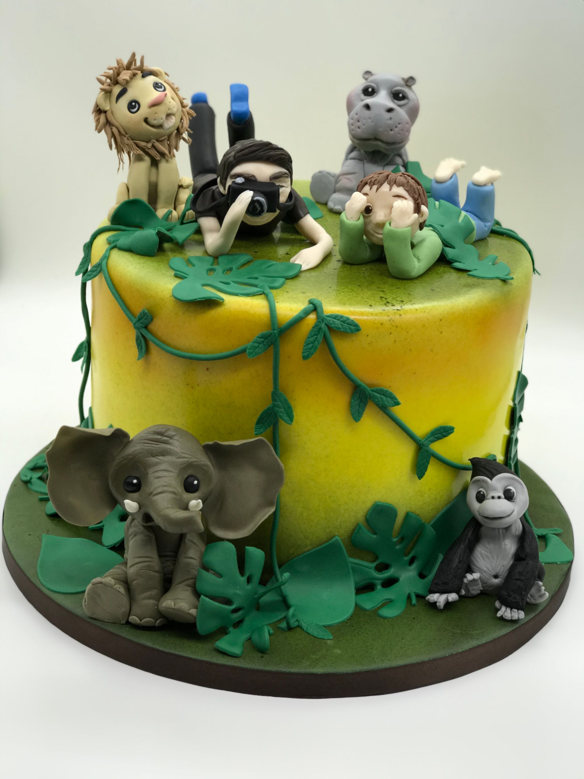 A yellow cake with animals on top of it