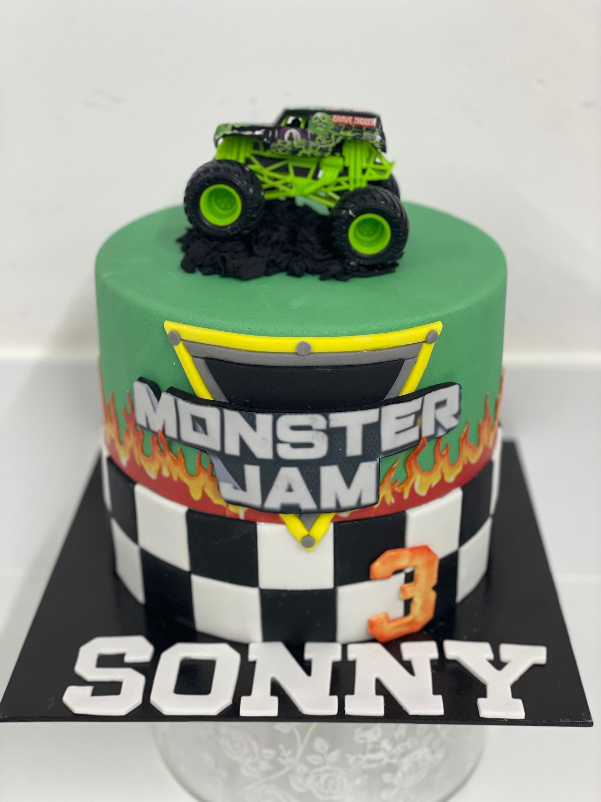 A monster jam cake for sonny with a monster truck on top