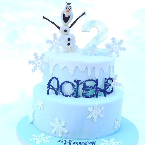 A birthday cake with a snowman and the number 2 on top