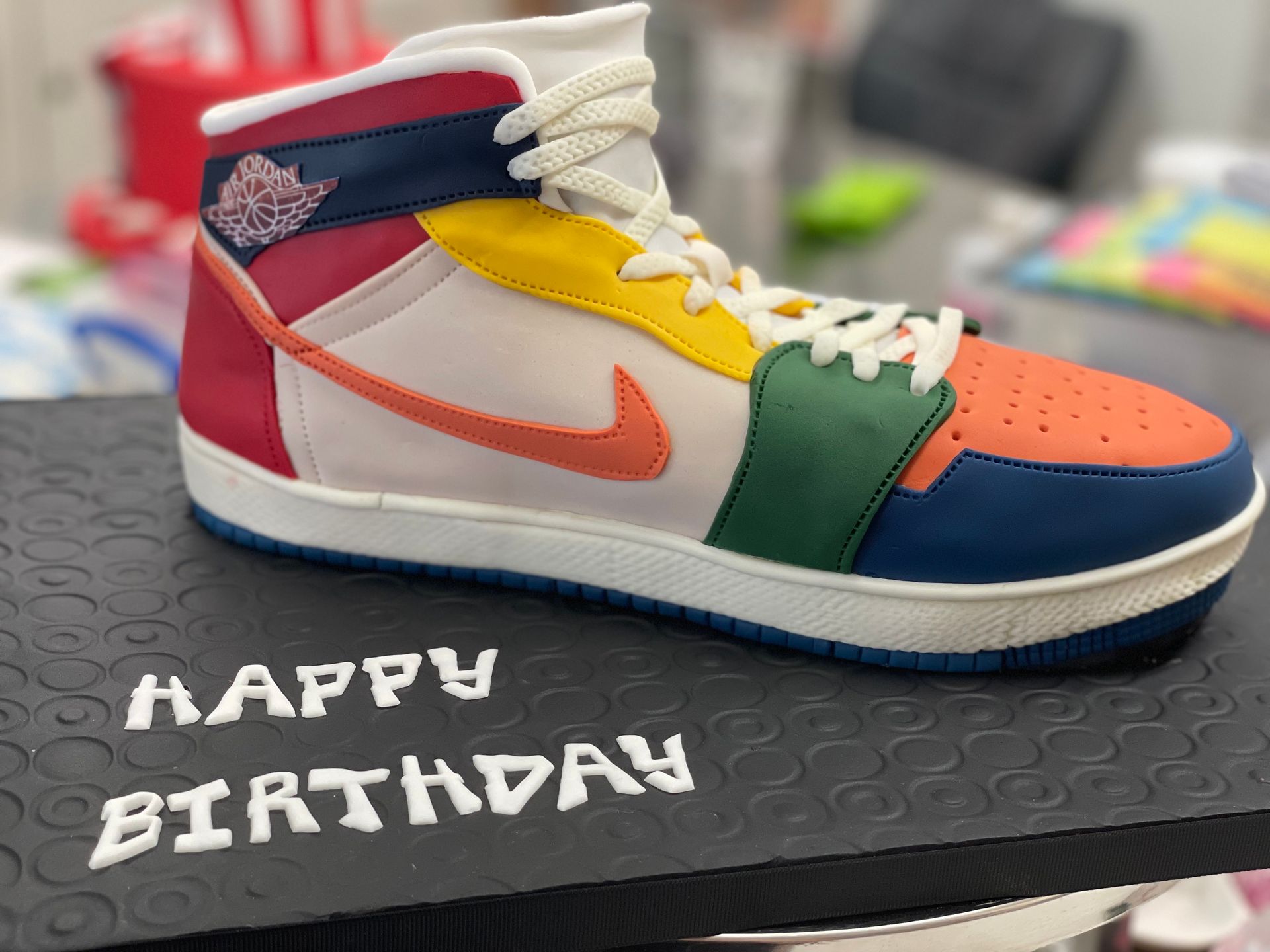 A birthday cake in the shape of a nike shoe