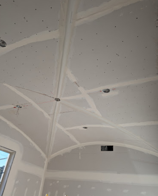 A room with a ceiling that is being remodeled.