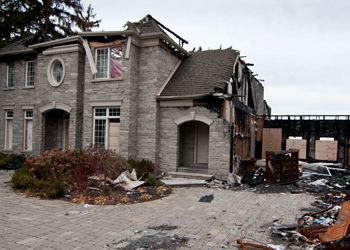 A large brick house that has been damaged by fire