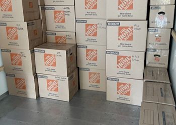 The home depot boxes are stacked on top of each other