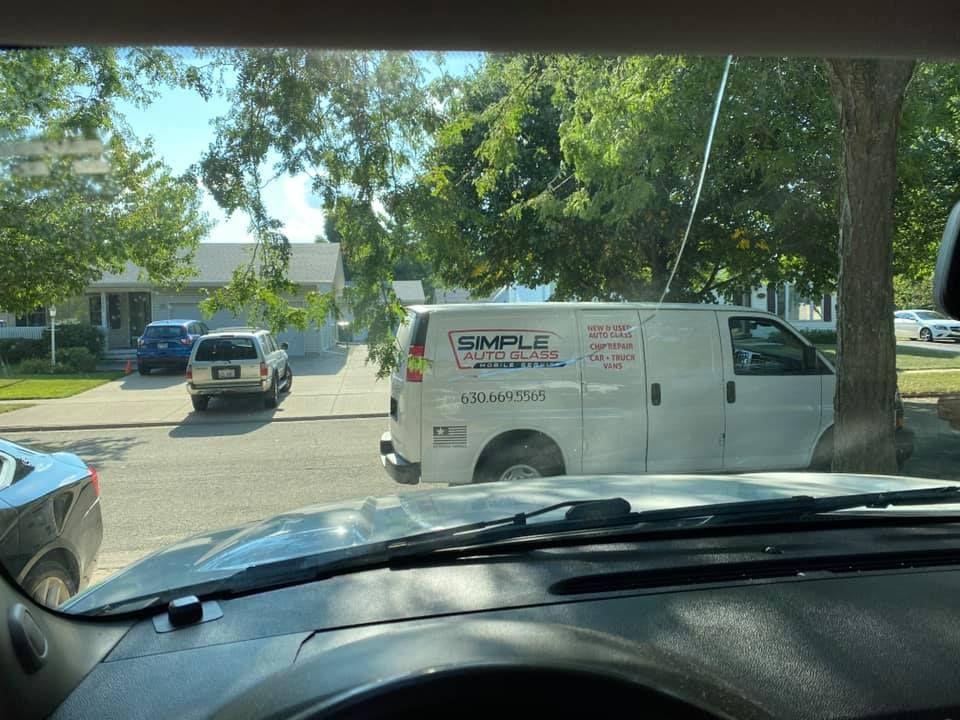 A white van is parked on the side of the road