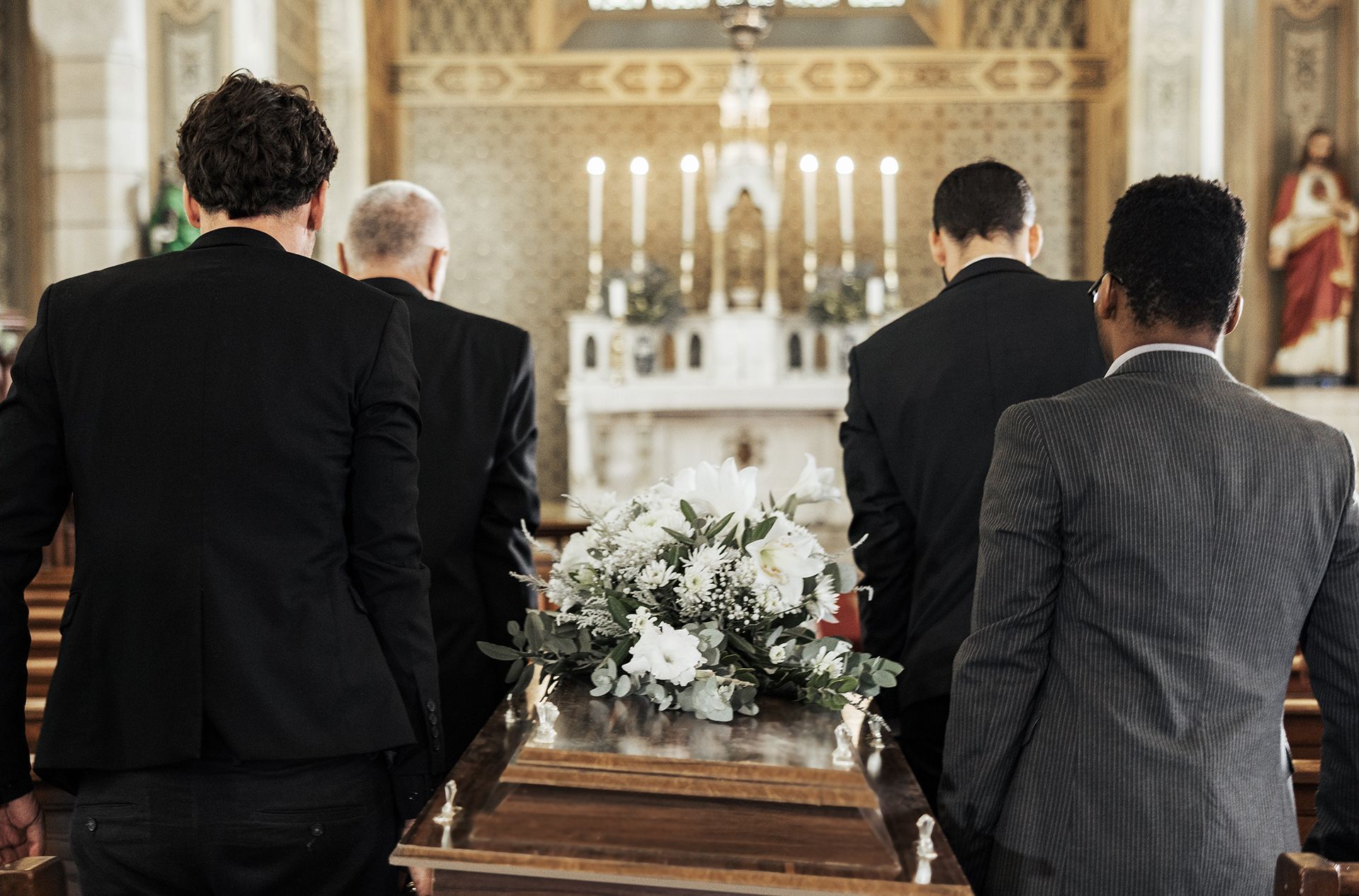 a woman is putting her hand on an american flag at a funeral .