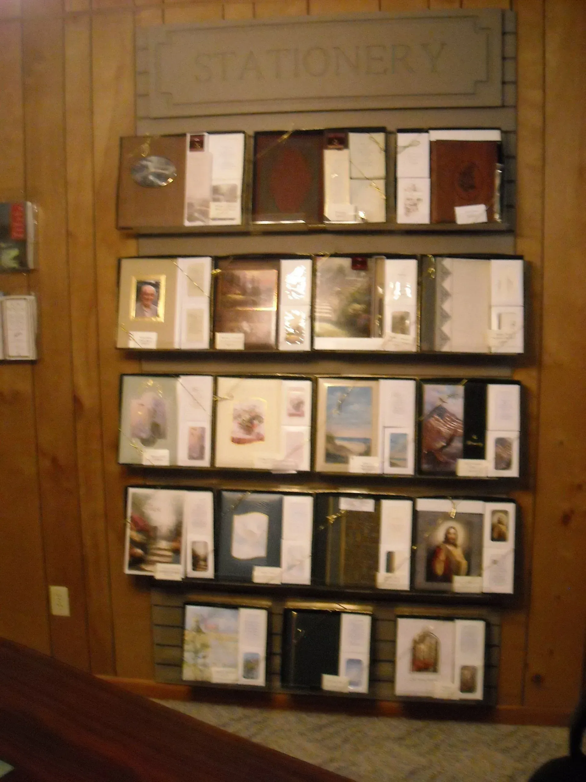 A display of greeting cards on a wooden wall