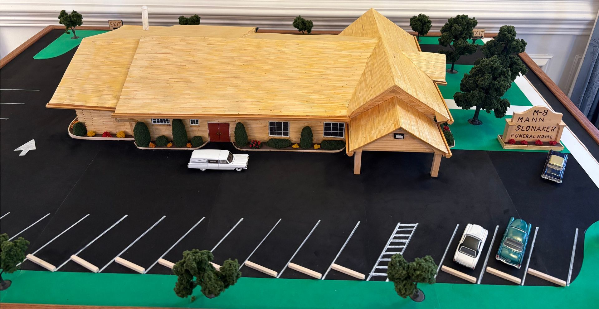 Rows of chairs in a room with a cross on the wall