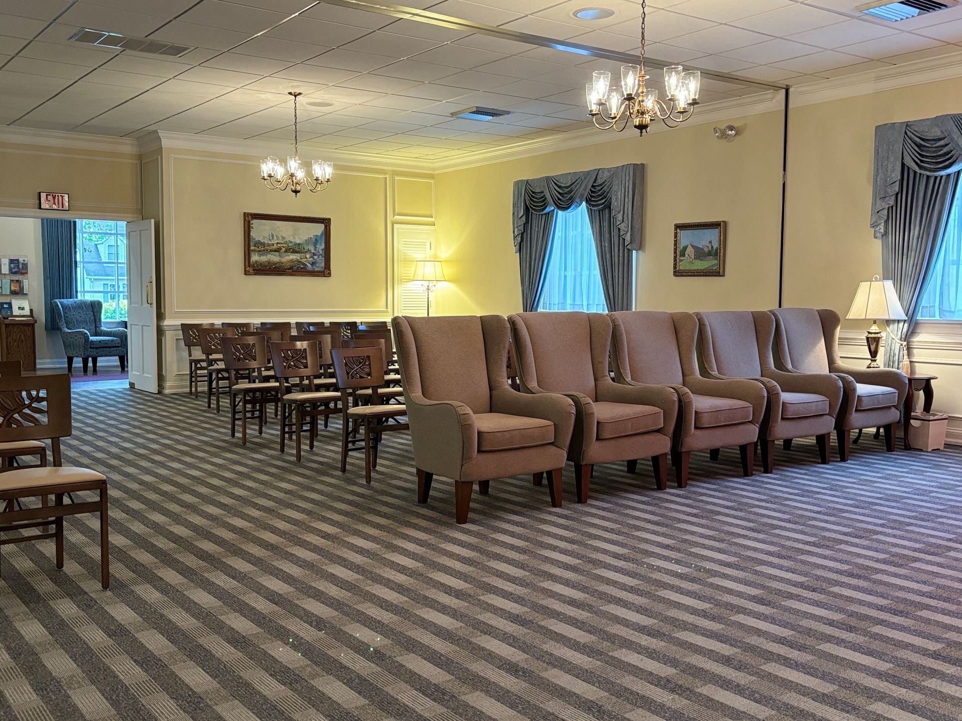 A large room with rows of chairs and a chandelier